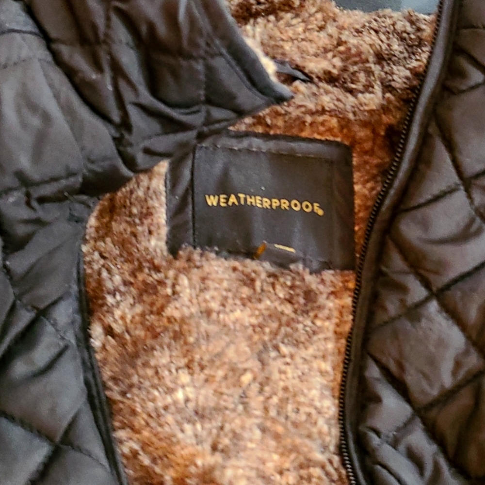 Black Weatherproof vest with brown faux fur and gold colored accents